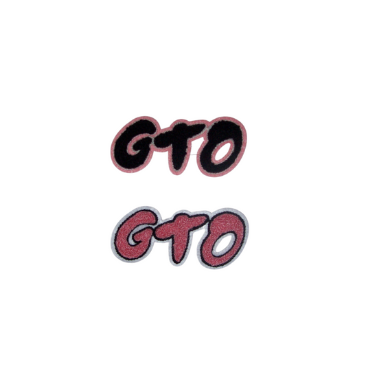 two chenille patches reading “gto” in bold script — one with a black fill and pink border, one fully pink with black outline